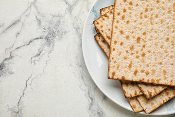 Plate with Jewish flatbread for Passover on white background