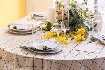 Stylish table setting with wedding invitations