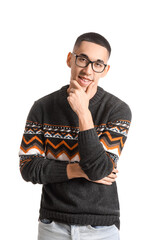 Handsome Asian man in knitted sweater on white background