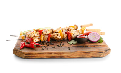 Wooden board of grilled chicken skewers with vegetables isolated on white background