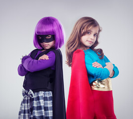 Not every girl wants to be a little princess. A studio shot of two little girls dressed up as a...