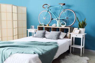Interior of stylish bedroom with modern bicycle