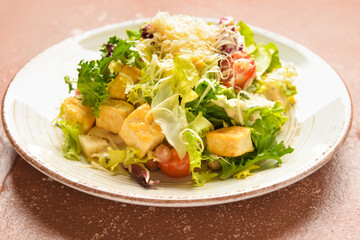 Plate of tasty vegan Caesar salad on grunge background