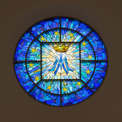 Round stained glass window inside the in the Co-Cathedral of the Sacred Heart Catholic church in downtown Houston, Texas