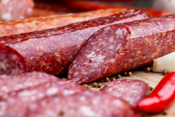 sliced pieces of sausage from meat are lying on a cutting board