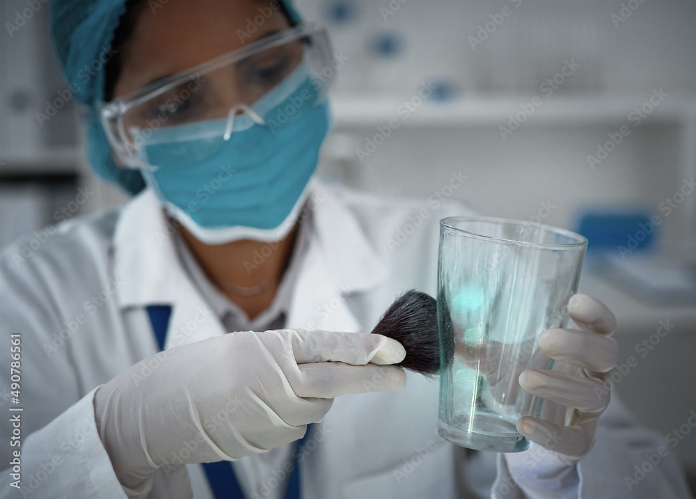 Poster now who do these belong to. high angle shot of a female forensic scientist dusting for prints in the