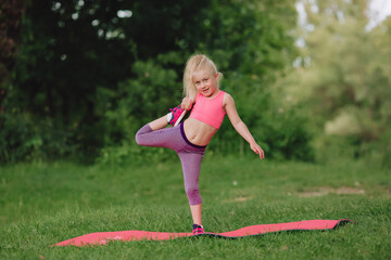 A sporty girl does gymnastic exercises on a mat.A healthy lifestyle.