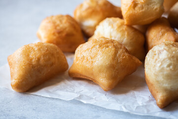 Heap of baursak on a baking paper. Close up. Festive Kazakh baking for Nauryz holiday.