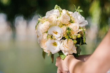 Bouquet of flowers in the hand of the bride