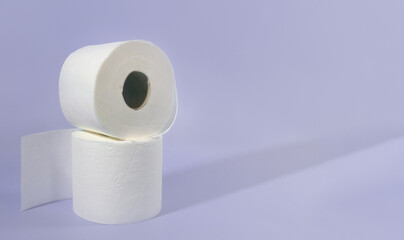 Rolls of toilet paper. Two rolls of toilet paper on a purple background. copy space