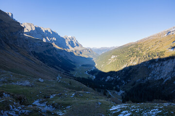 Naklejka na ściany i meble Amazing Landscape in the hearth of Switzerland. Epic scenery with the clouds and fog. Wonderful sun rays through the clouds and later an amazing sunset and sunrise. Road trip through Switzerland.