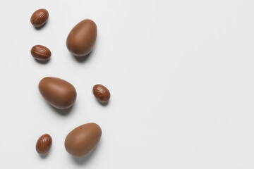 Delicious chocolate eggs on light background