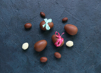 Composition with chocolate Easter eggs on dark background