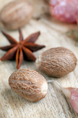 a whole nutmeg on a wooden board