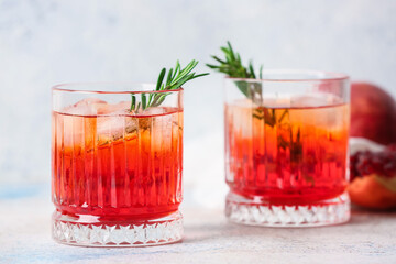 Glasses of tasty pomegranate cocktail on white background