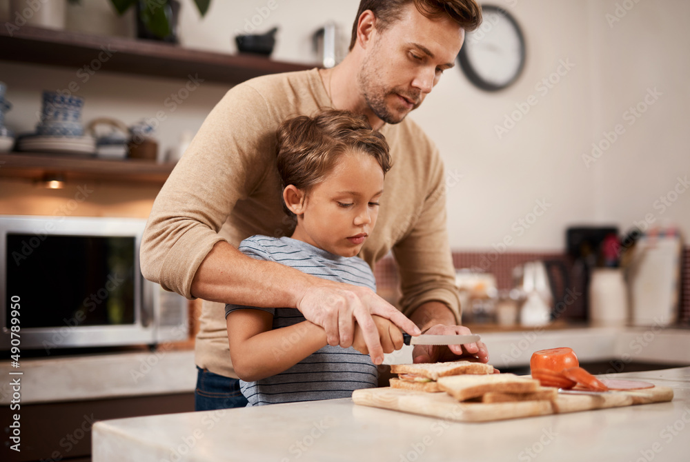 Wall mural I made my own sandwich today. Shot of a young boy making a sandwich with the help of his father.