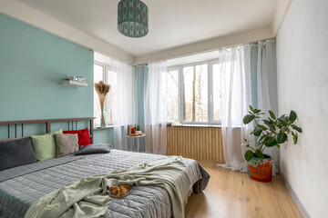 Headboard with pillows. Cozy bedroom in a small apartment