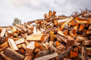 A pile of split firewood for heating a house.