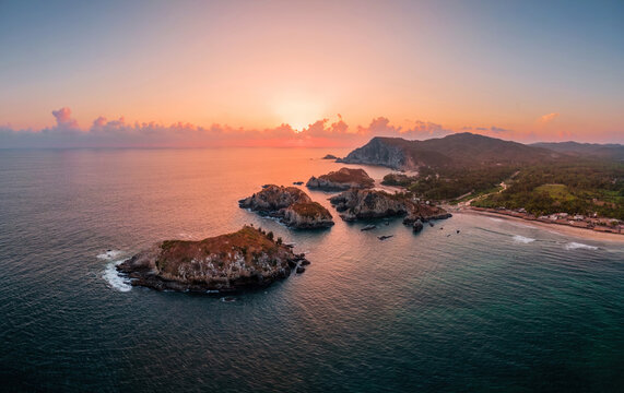 Sunset over the rocky islands at the Maruata beach, Michoacan, Mexico