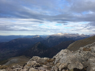 Distant view of the Spanish Pyrenees mountains and the cloudy sky on the background