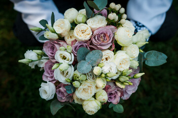 Bouquet of flowers in the groom's hand