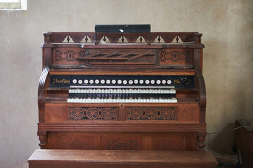 Old wooden harmonium inside a church