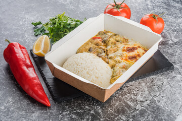 Several varieties of melted cheese with meat and rice in a lunch box