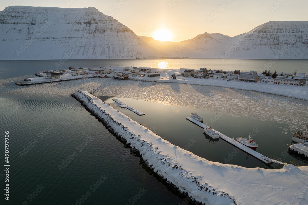 Wall mural Aerial view of the port and the lake covered with snow and surrounded by mountains