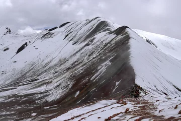 Papier Peint photo Vinicunca Group of people hiking to the Peru Vinicunca Rainbow Mountain covered with snow