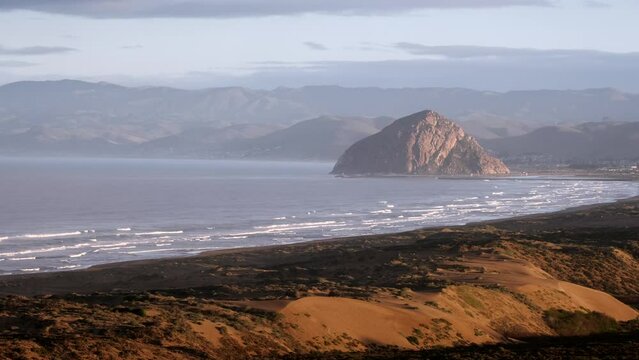 Sunrise overlooking sand dunes and Morro Rock
