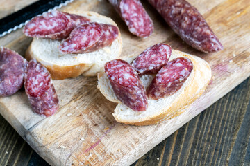 sliced pieces of sausage from meat are lying on a cutting board