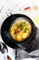Pea soup with bacon and parsley in a bowl on a white background. Selective focus