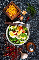 Salad of eggs and corn kernels with vegetables. Close-up