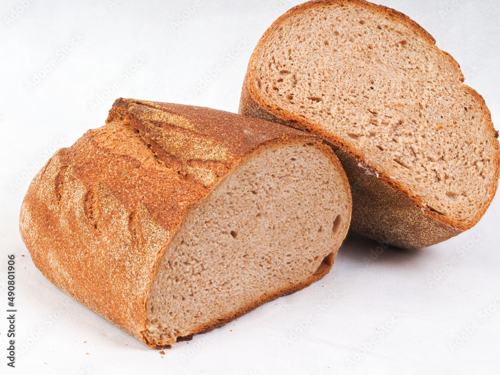 Wall mural Closeup shot of the farro and spelt bread cut in half isolated on the white background