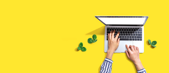 Laptop computer with shamrock leaves - flat lay