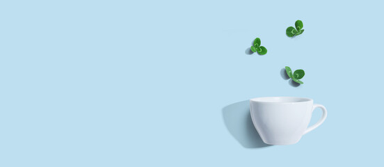 Shamrock leaves with coffee cup - flat lay