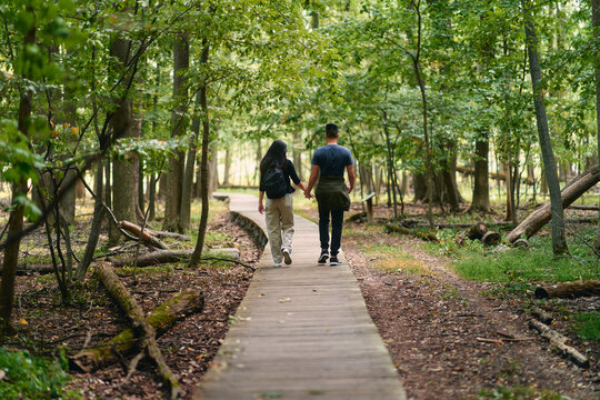 Closeup Of A Couple From Behind Walking In The Park