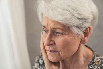 portrait of an elderly pensioner woman suffering from dementia and being depressed close up shot. High quality photo