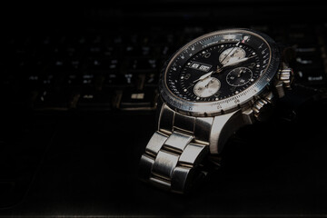 Close up of stainless steel chronograph watch - obrazy, fototapety, plakaty