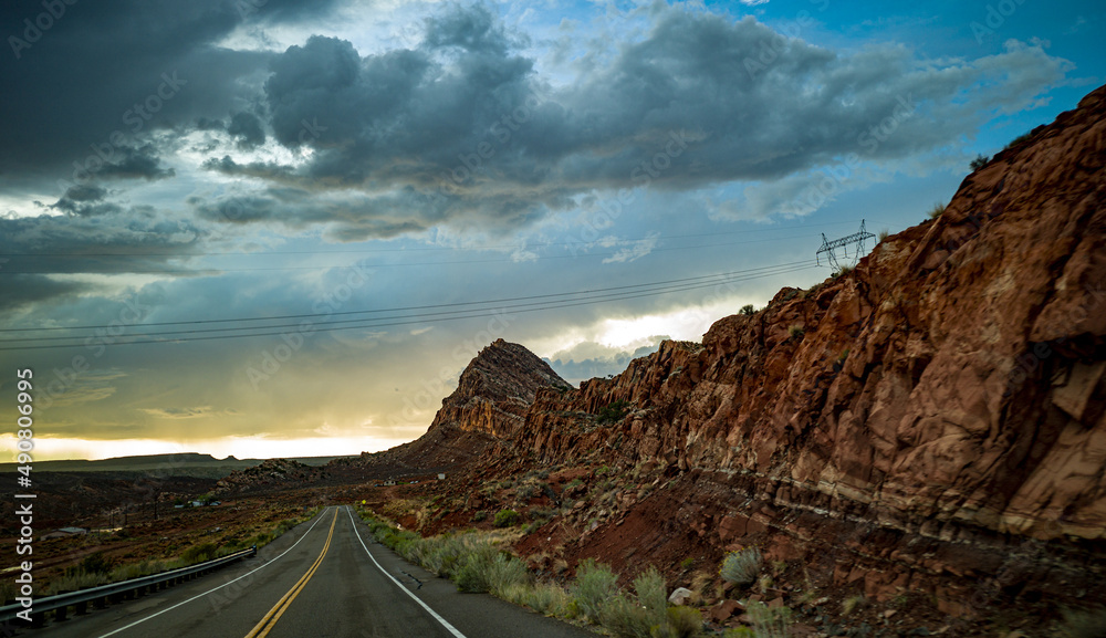 Poster Spectacular view on a highway of rocky cliffs on cloudy sky background in Arizona, USA