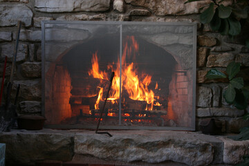 Wall mural stone fireplace with a lit roaring fire in Grandma's