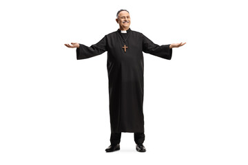 Full length portrait of a smiling mature priest standing and spreading arms