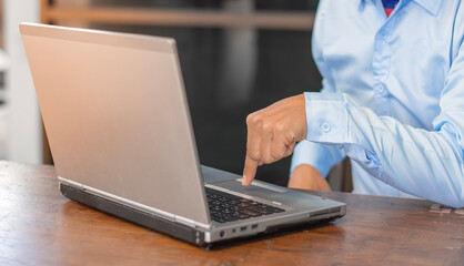 Young man working on a laptop at home, Technology & Business Concepts.