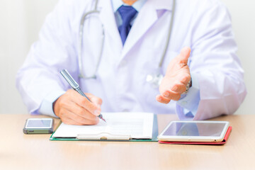 doctor writing on clipboard
