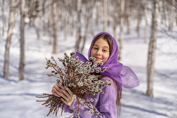 On a sunny spring day, a young girl walks, travels through the forest, collects willow for the Easter holiday. The girl walks among the birches, collects willows, rejoices, laughs, the Easter holiday.