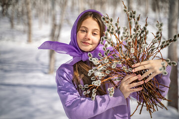 On a sunny spring day, a young girl walks, travels through the forest, collects willow for the Easter holiday. The girl walks among the birches, collects willows, rejoices, laughs, the Easter holiday.