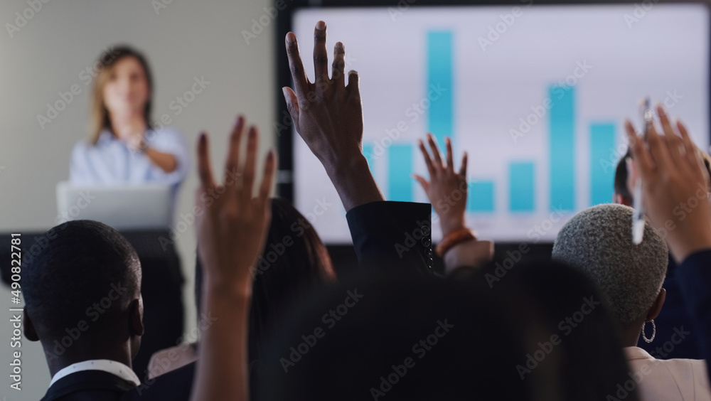 Poster Opening the floor for a QA session. Rearview shot of a group of businesspeople raising their hands during a conference in an office.