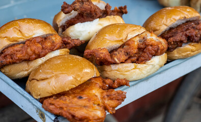 Delicious fried chicken burgers on the street food market close up