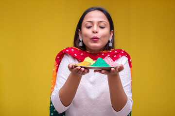 Portraits of young woman celebrating holi