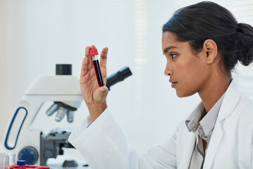 Determining the root cause of her latest medical case. Cropped shot of a young female scientist...